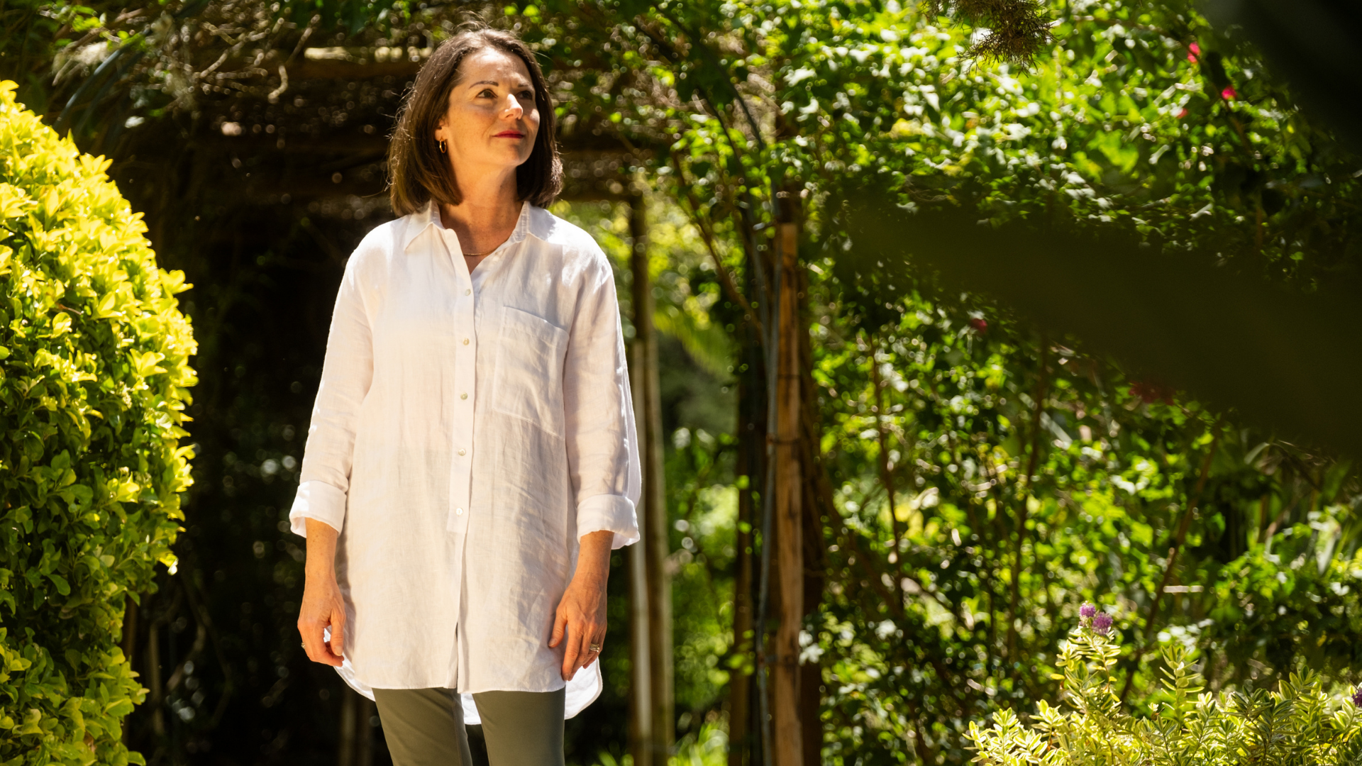 A woman wearing white long sleeve in the garden